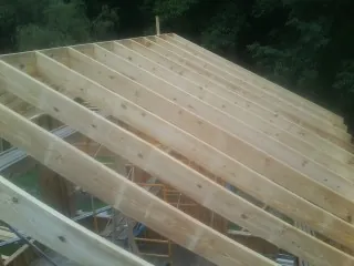New roof rafters set over an addition before sheathing in Tucson